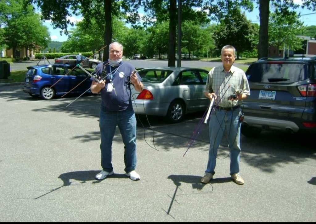 Two fox hunters in a parking lot at a park trying to locate the transmitter.